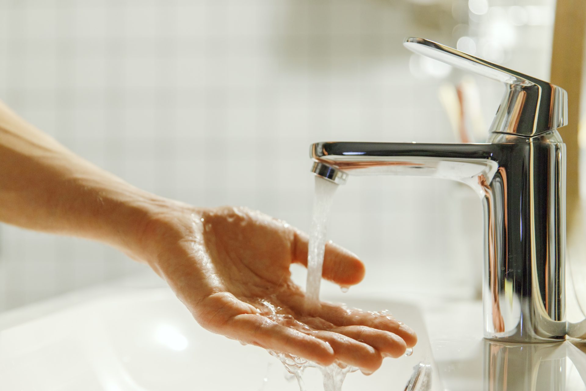man washing and cleaning her hand in bathroom fing 2023 11 27 05 09 57 utc
