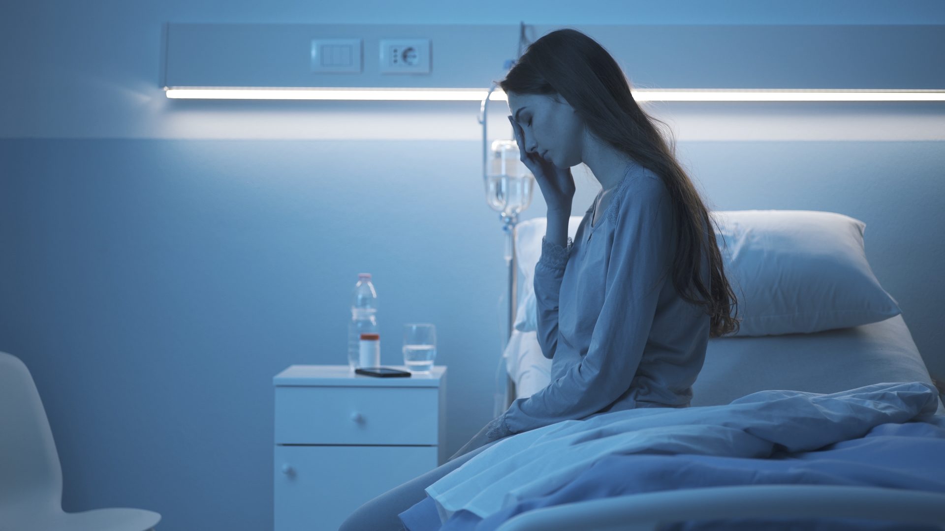 sad sleepless patient sitting on the hospital bed 2023 11 27 05 13 06 utc