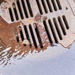 water draining into a sewer manhole after rain on 2023 11 27 05 11 28 utc