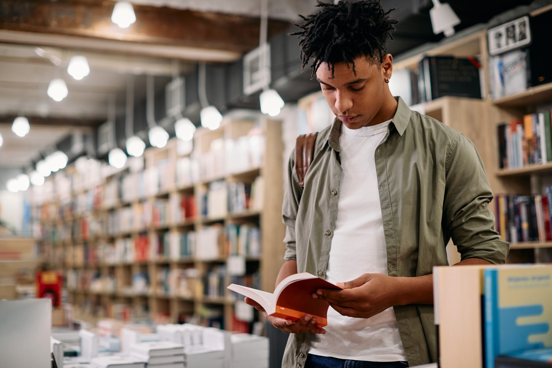 young black student reading a book in a library 2023 11 27 05 00 23 utc