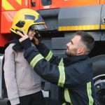 a fireman shows his work to his young son a boy i 2023 11 27 05 16 06 utc