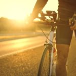 man holding bicycle on empty sunset road 2023 11 27 05 12 25 utc