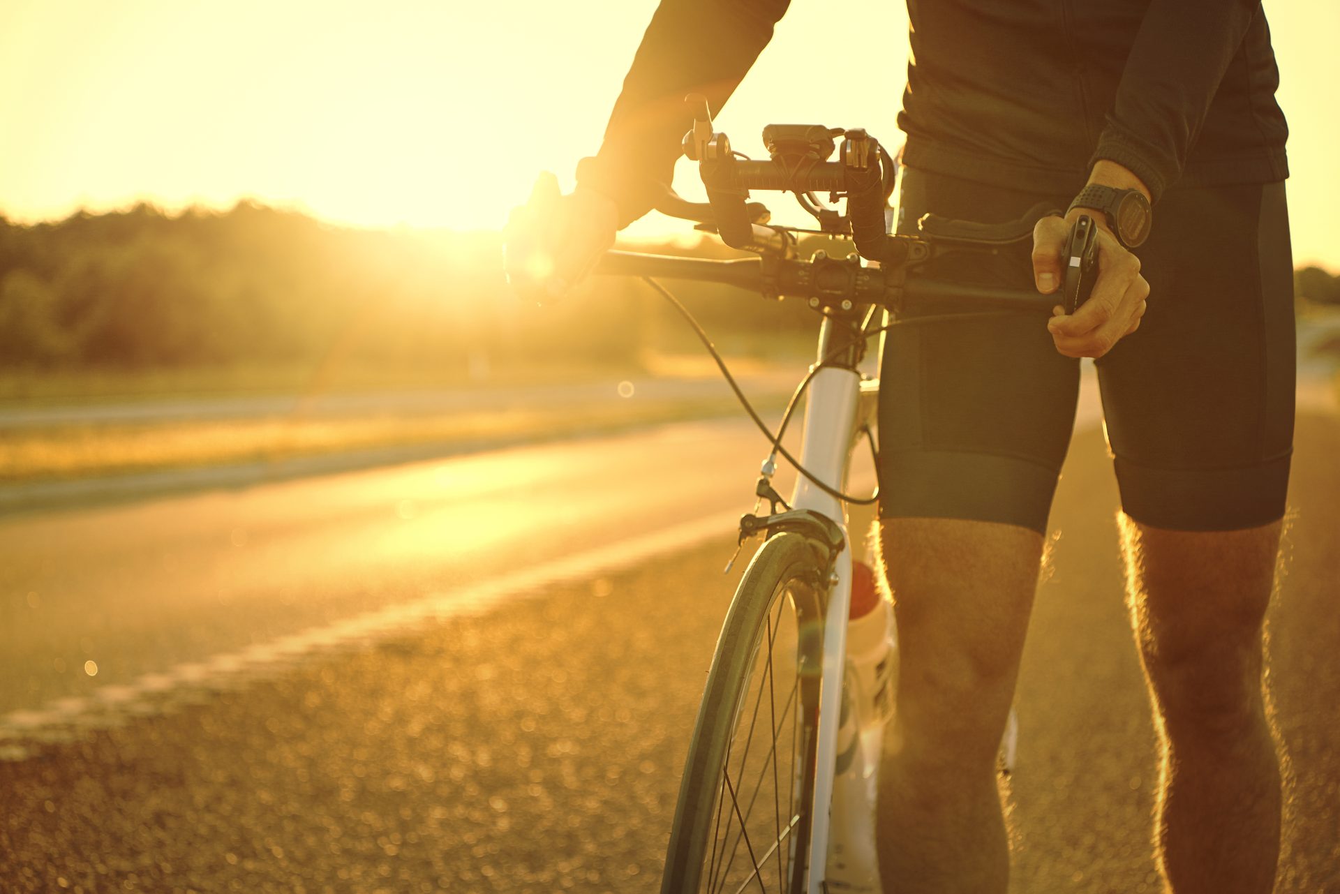 man holding bicycle on empty sunset road 2023 11 27 05 12 25 utc
