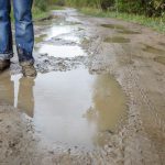 man in dirty shoes standing in the mud 2023 11 27 05 27 55 utc