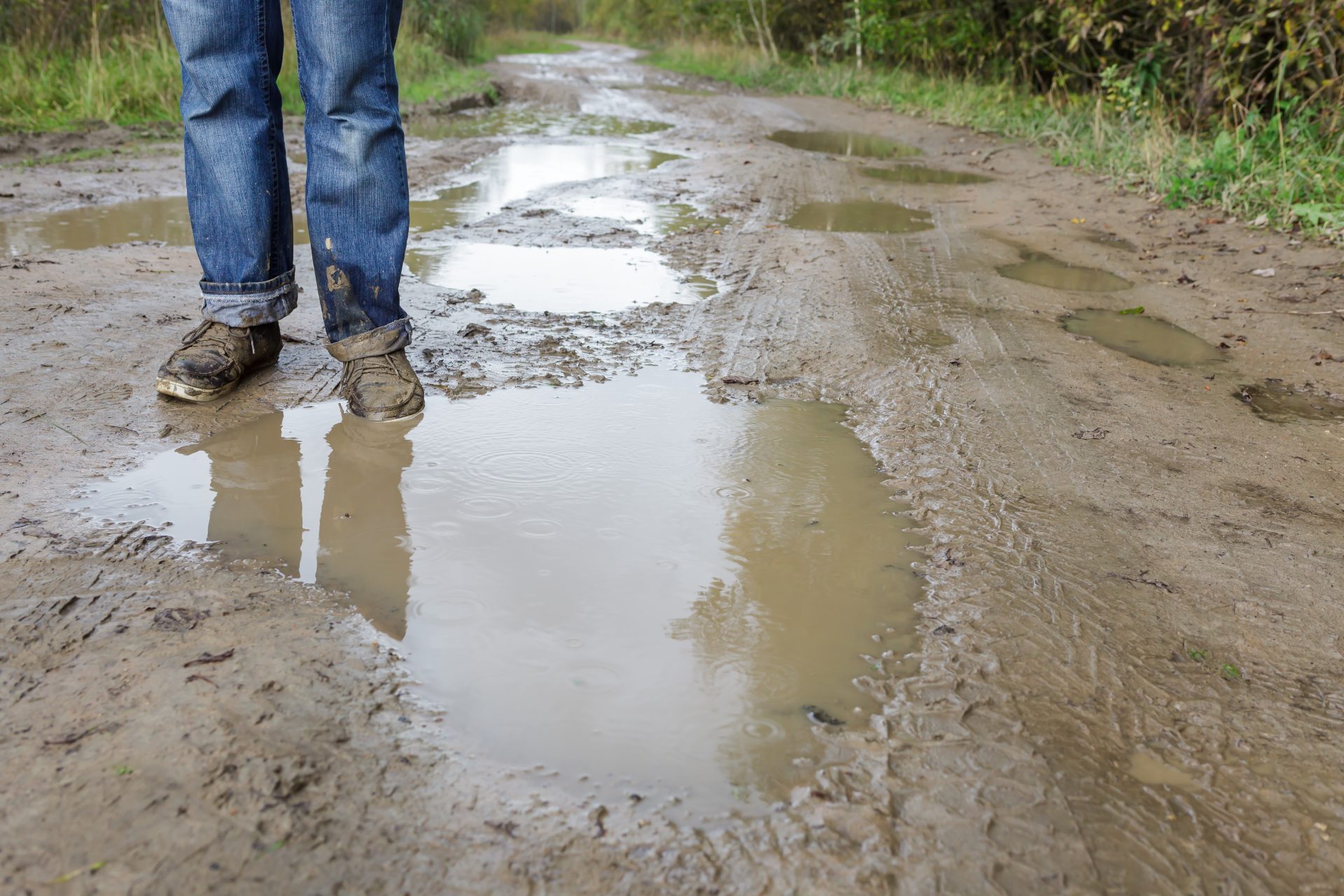 man in dirty shoes standing in the mud 2023 11 27 05 27 55 utc