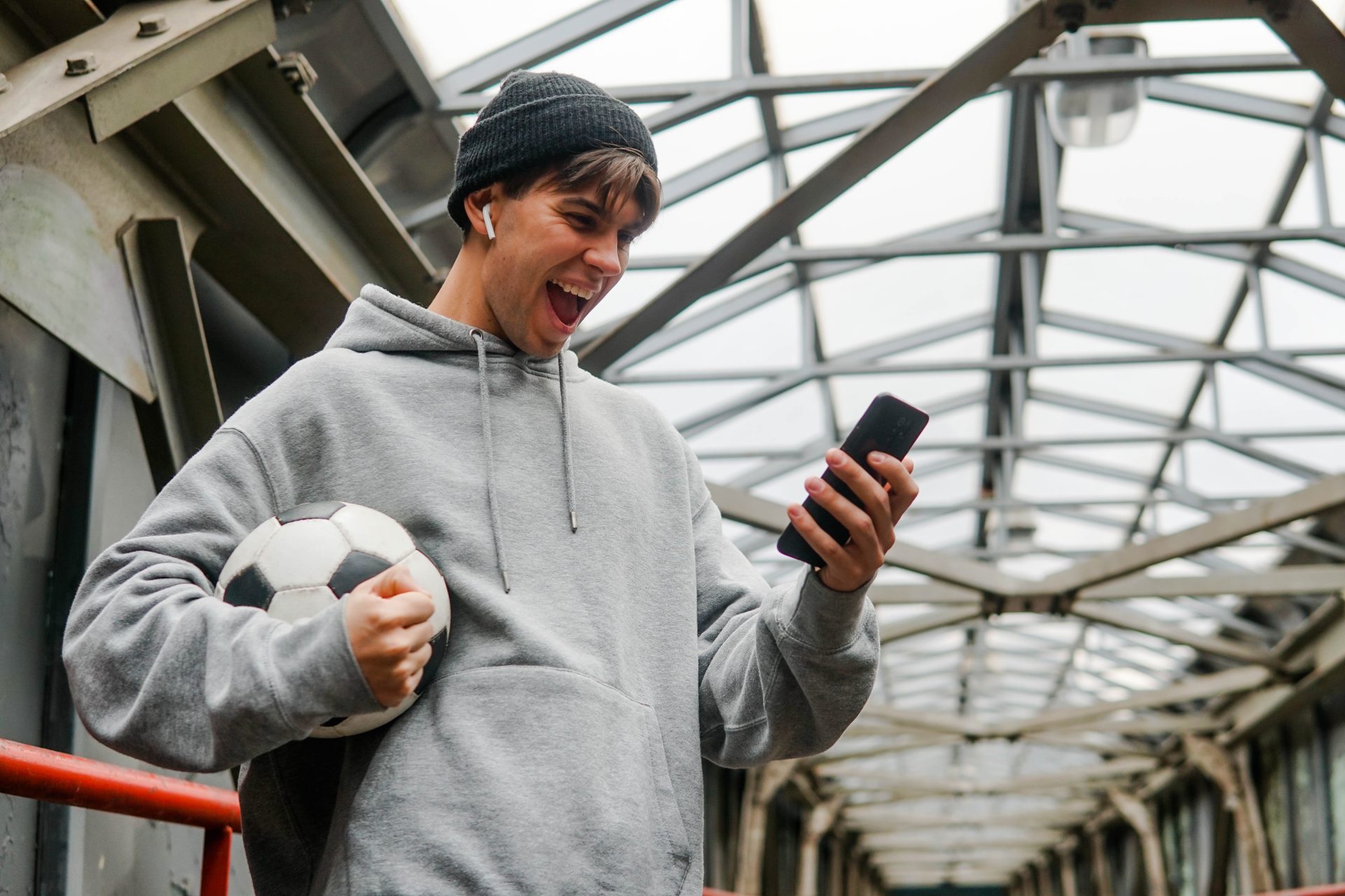 young hipster man holding smartphone and celebrate 2023 11 27 05 06 19 utc