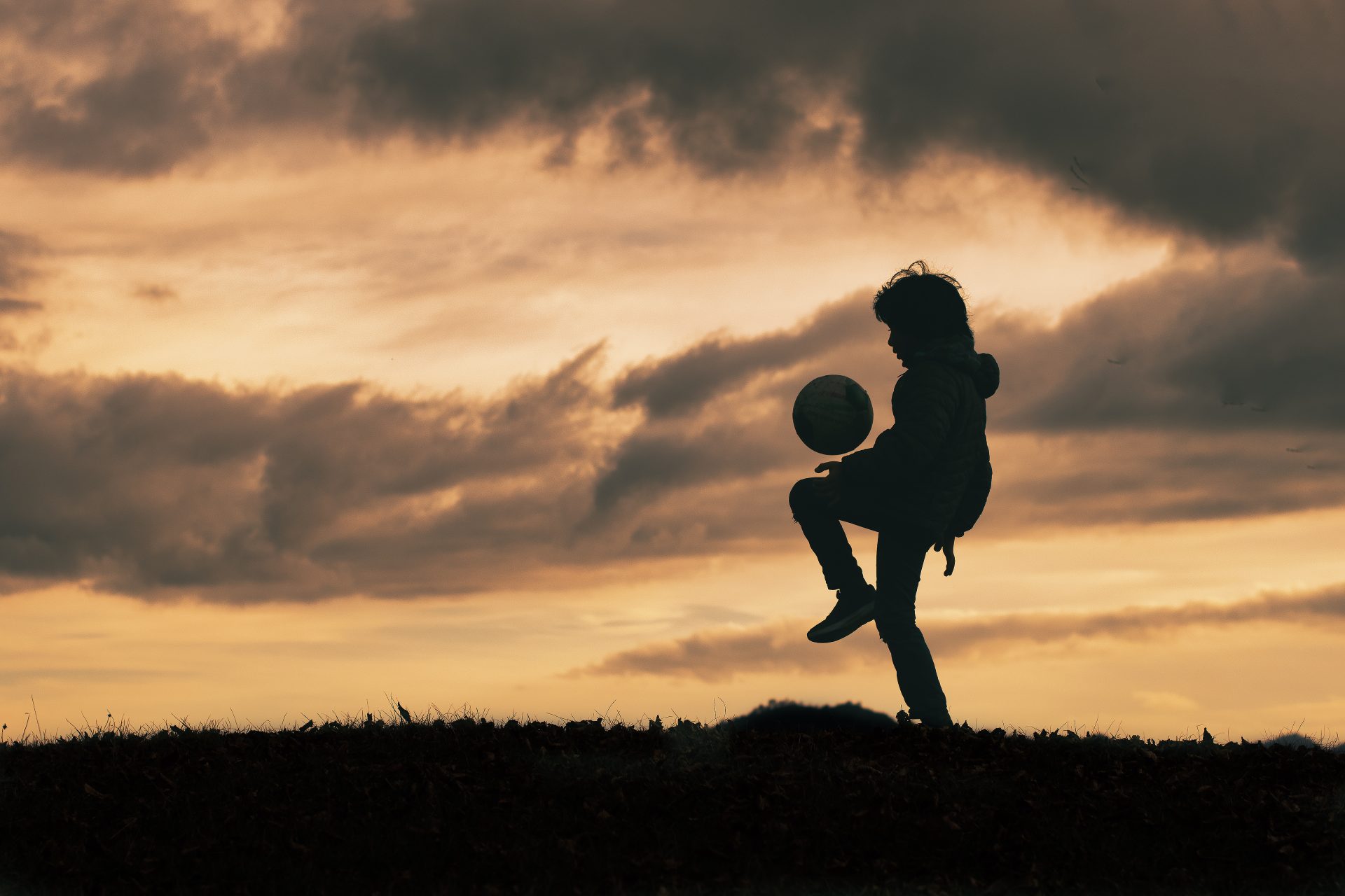 child in silhouette dribbles and plays with soccer 2023 11 27 05 10 28 utc