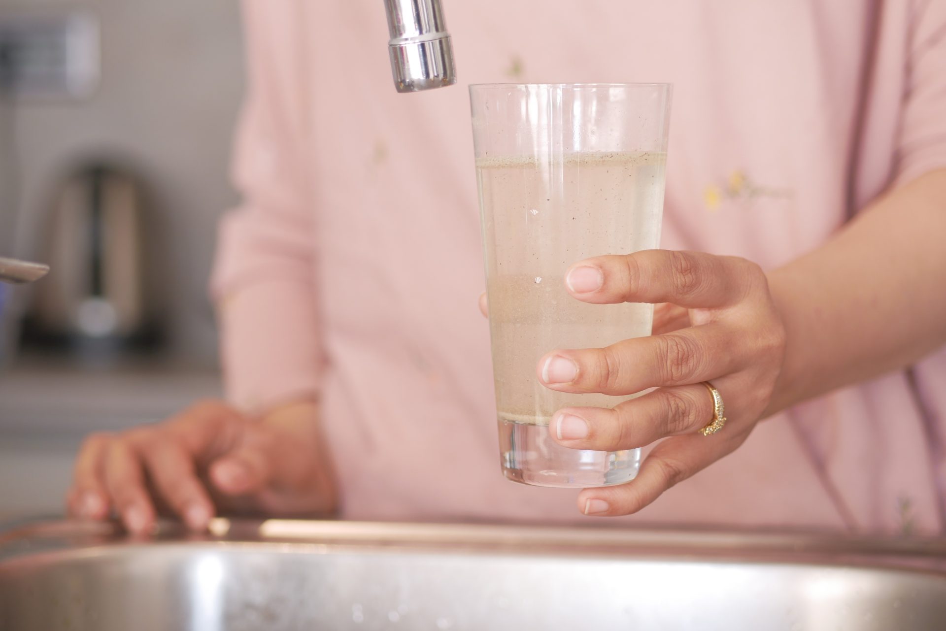 dirty water pouring from a faucet tap in a glass 2023 11 27 05 15 45 utc