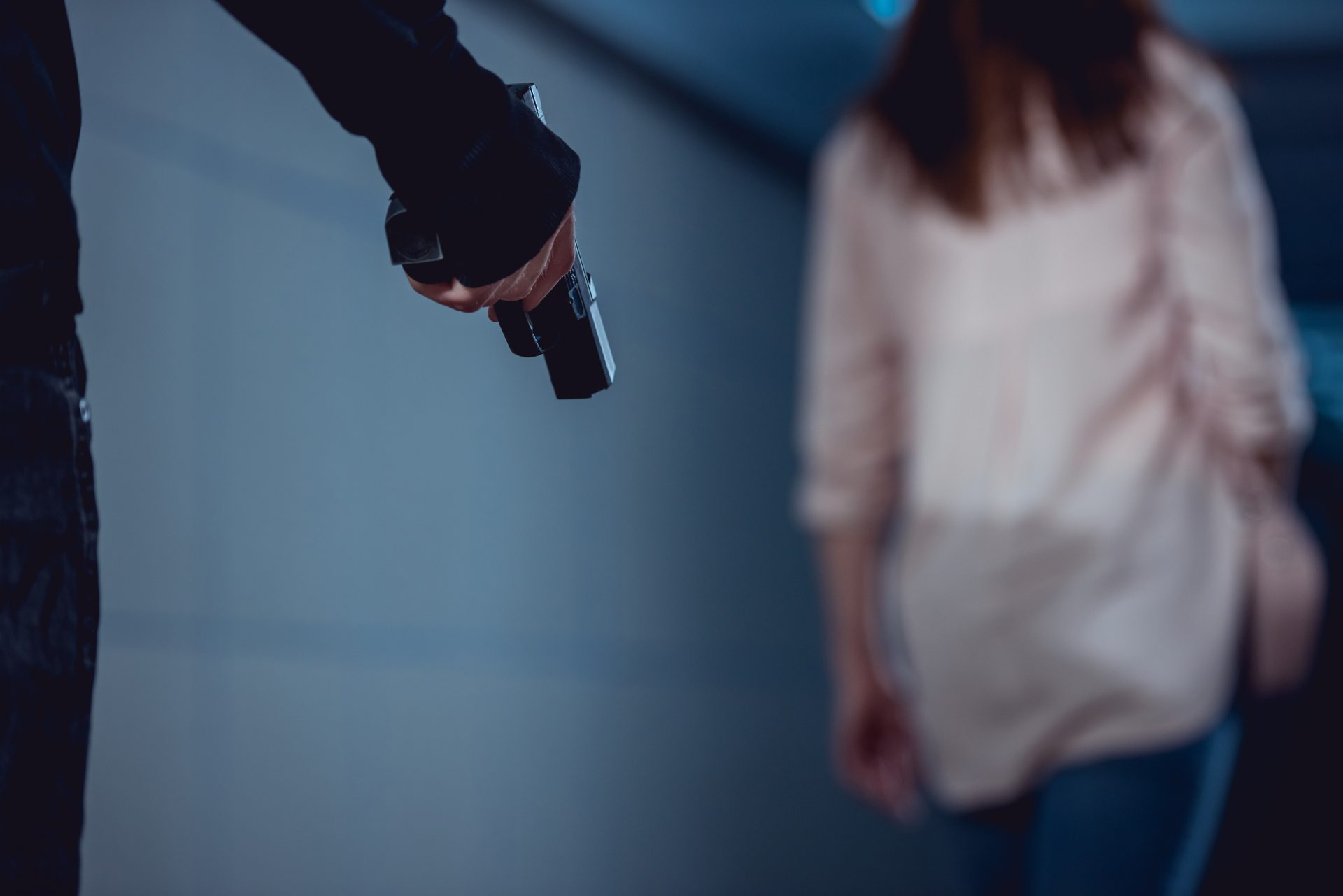 selective focus of robber holding gun near woman 2023 11 27 05 29