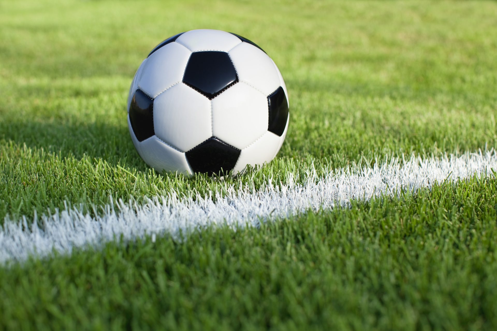 soccer ball on grass field with stripe 2023 11 27 05 34 44 utc