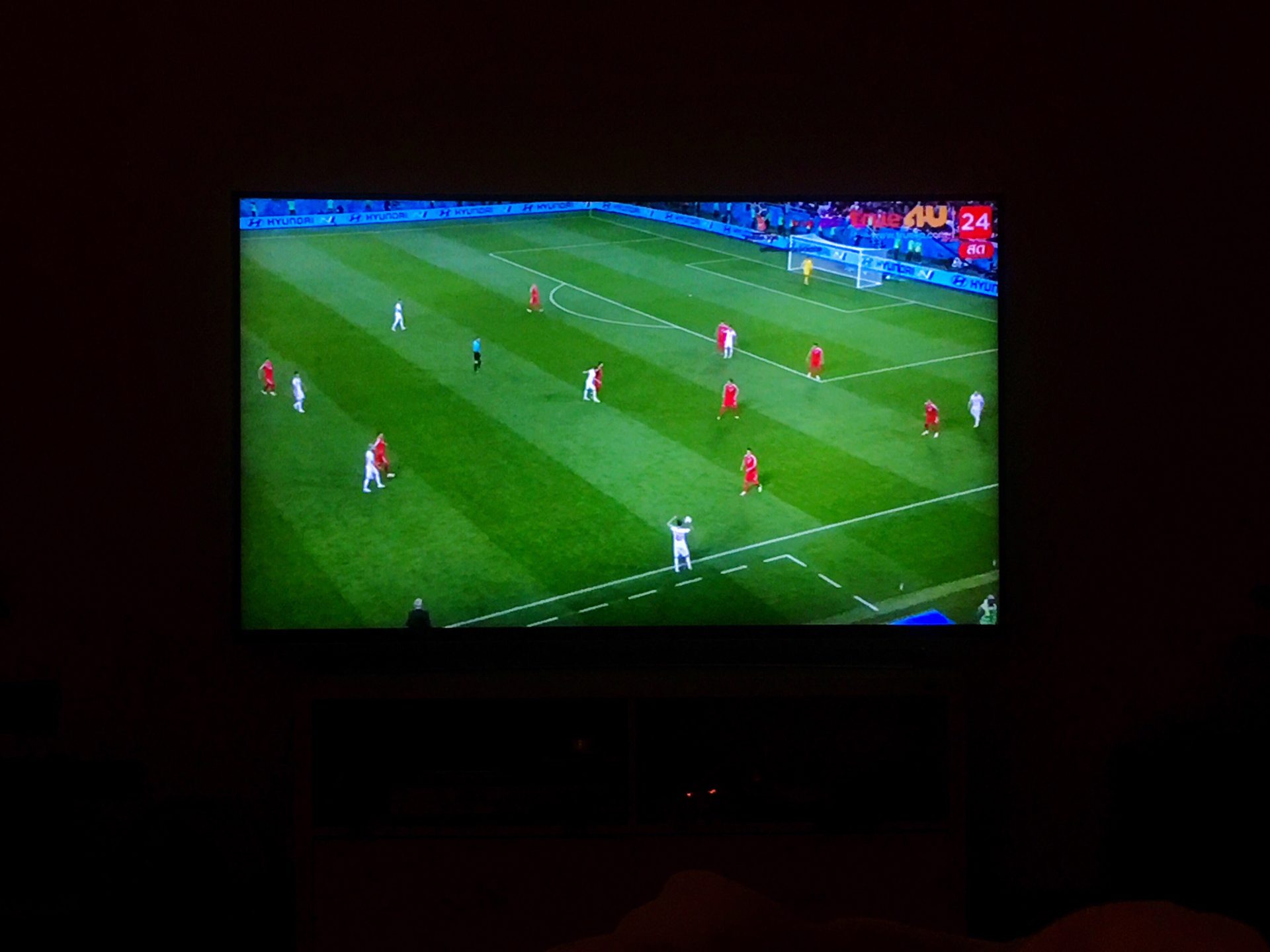 soccer game on television screen in the dark room 2023 11 27 05 35 13 utc 1