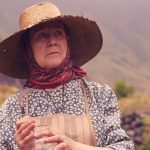 an elderly peasant woman wearing a hat holds a sma 2023 11 27 05 01 23 utc