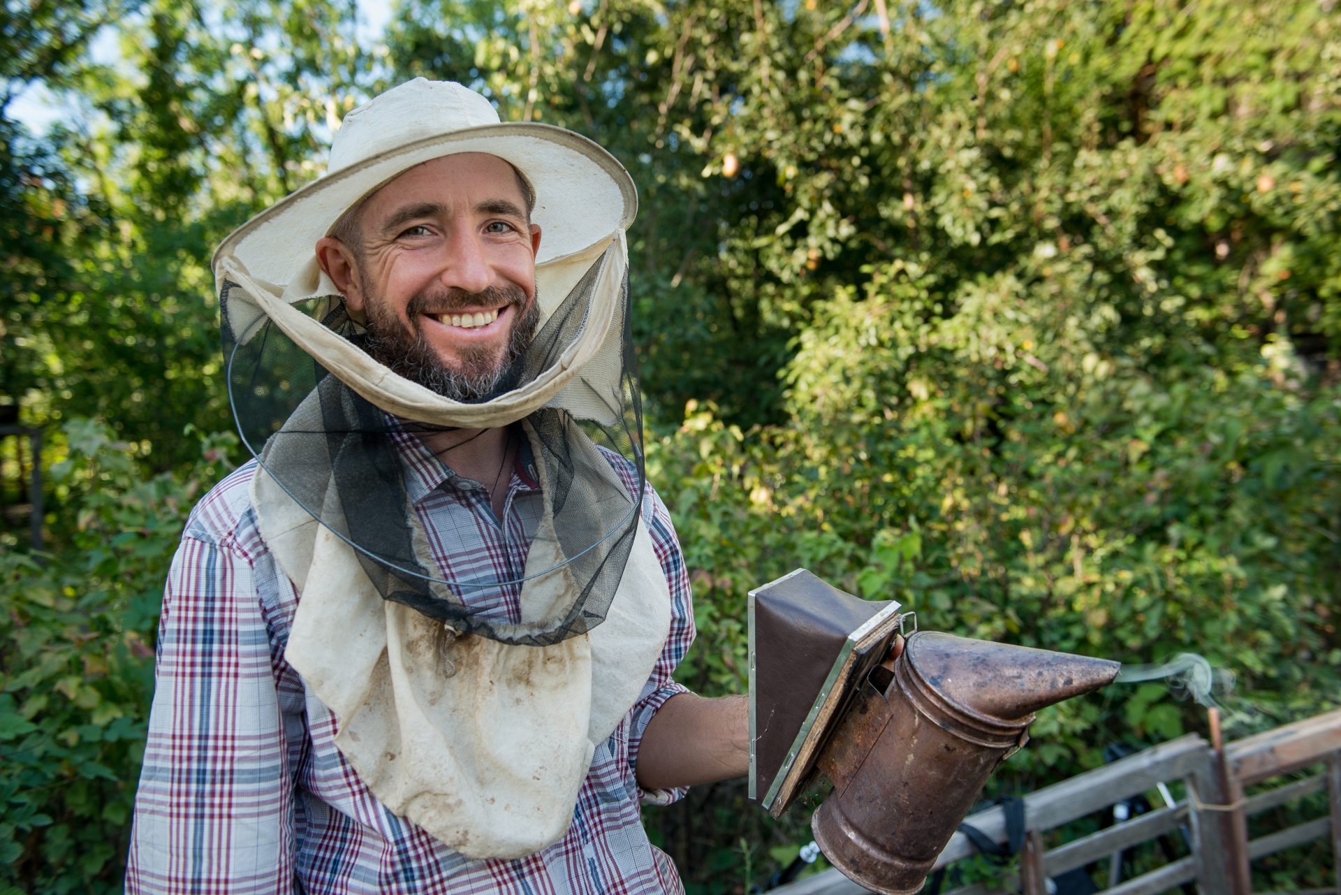 beekeeper in a protective mask smiling 2024 07 10 04 48 36 utc