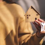 closeup image of a woman holding a wooden house mo 2024 07 23 22 40 56 utc
