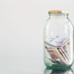colombian banknotes in glass jar on glass table 2023 11 27 05 17 15 utc