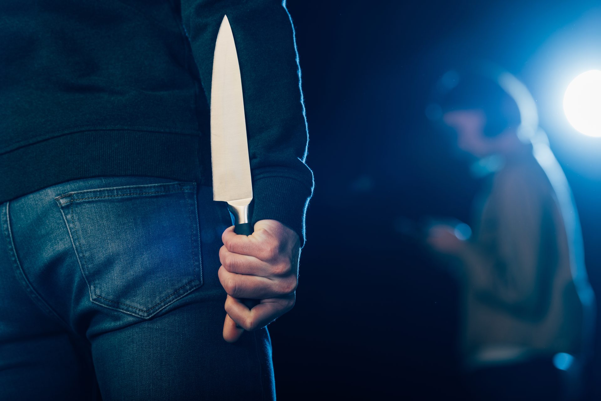 cropped view of murderer hiding knife behind back 2023 11 27 05 12 32 utc