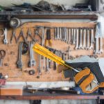 hand in glove holding screwdriver with tools 2023 11 27 04 53 49 utc