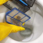 hands in rubber gloves throw out trash in toilet 2024 03 05 14 55 07 utc
