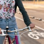 hands of woman riding bicycle by the bike path 2023 11 27 05 05 38 utc