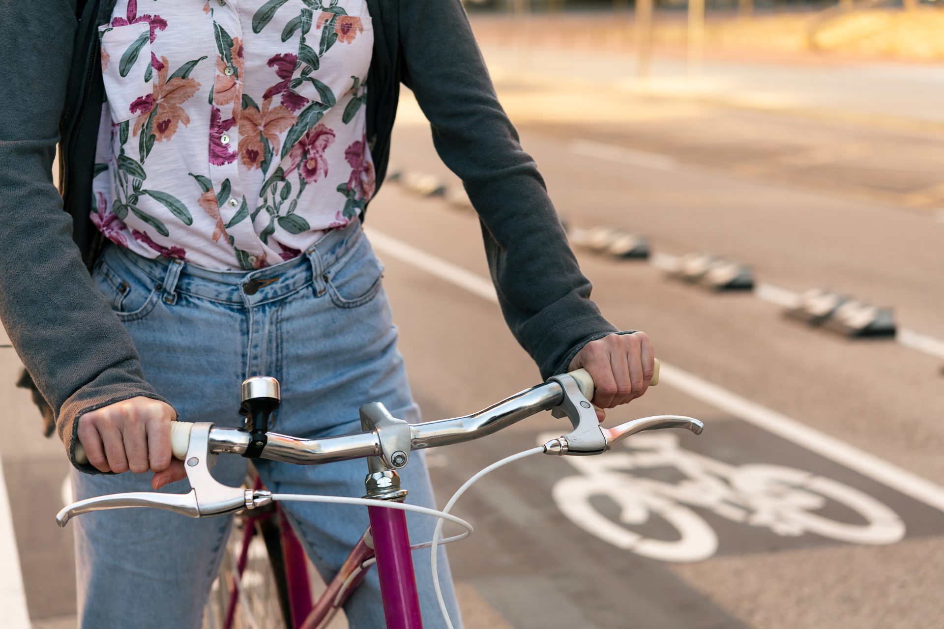 hands of woman riding bicycle by the bike path 2023 11 27 05 05 38 utc