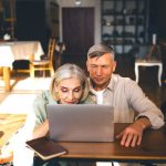 happy elderly couple using laptop in modern apartm 2024 01 26 18 39 51 utc