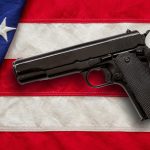 pistol on us america flag background top view gu 2023 11 27 04 54 33 utc