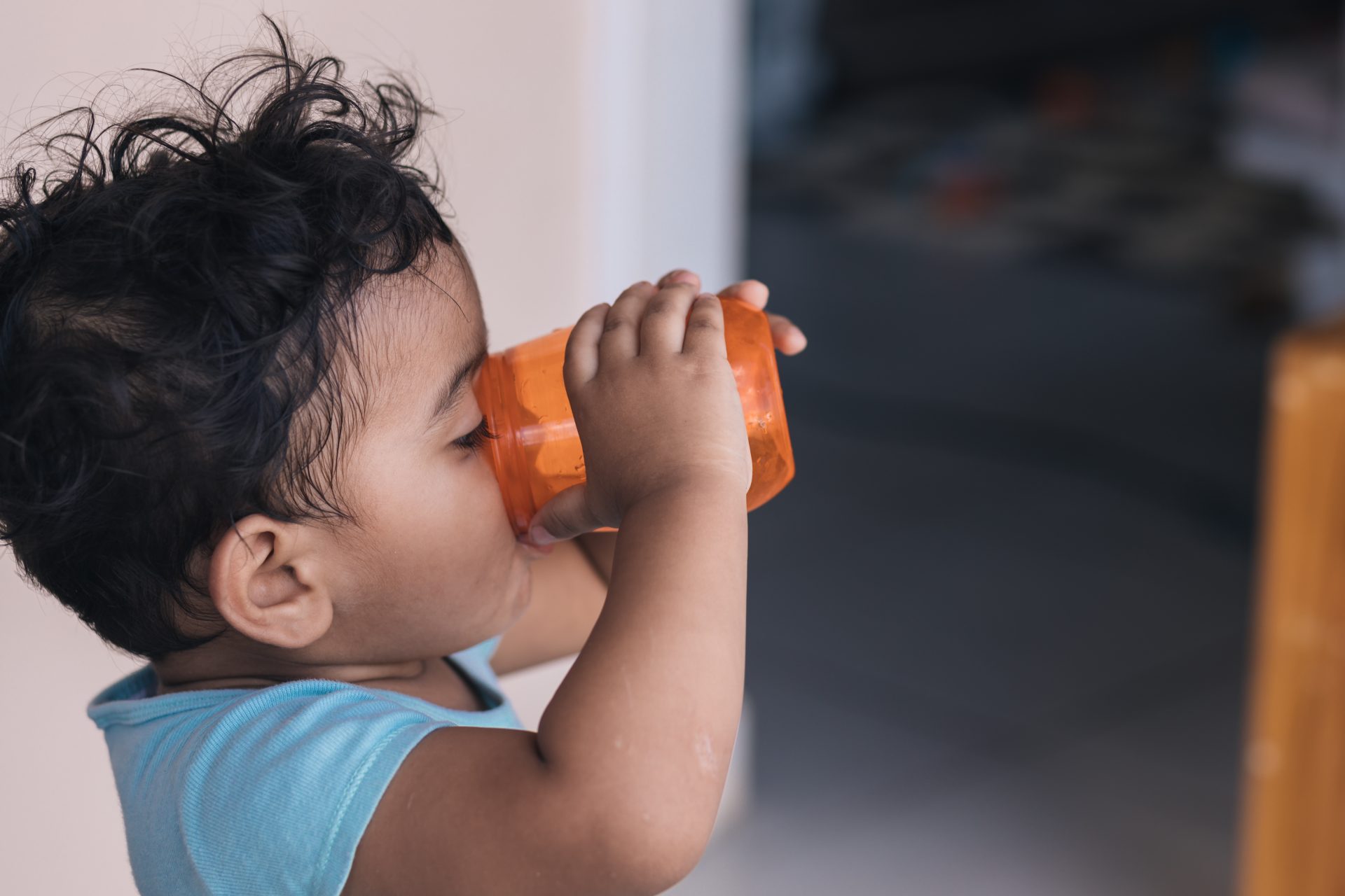 drink water in an orange glass outside the house 2023 11 27 05 16 09 utc