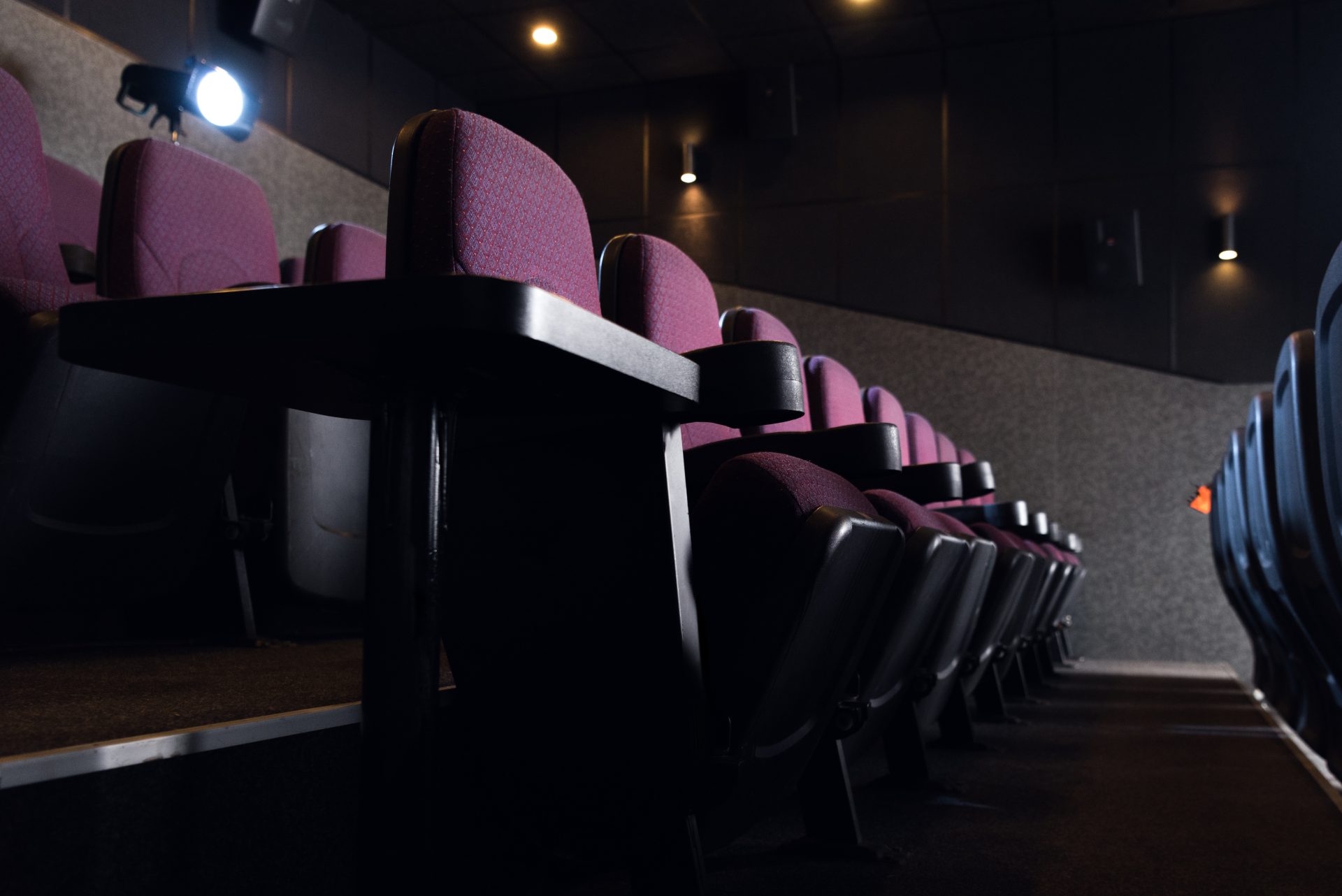 red seats in empty dark movie theater 2023 11 27 05 04 37 utc