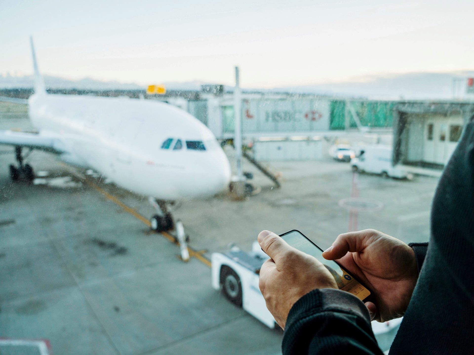 man using phone at the airport 2023 11 27 05 31 27 utc