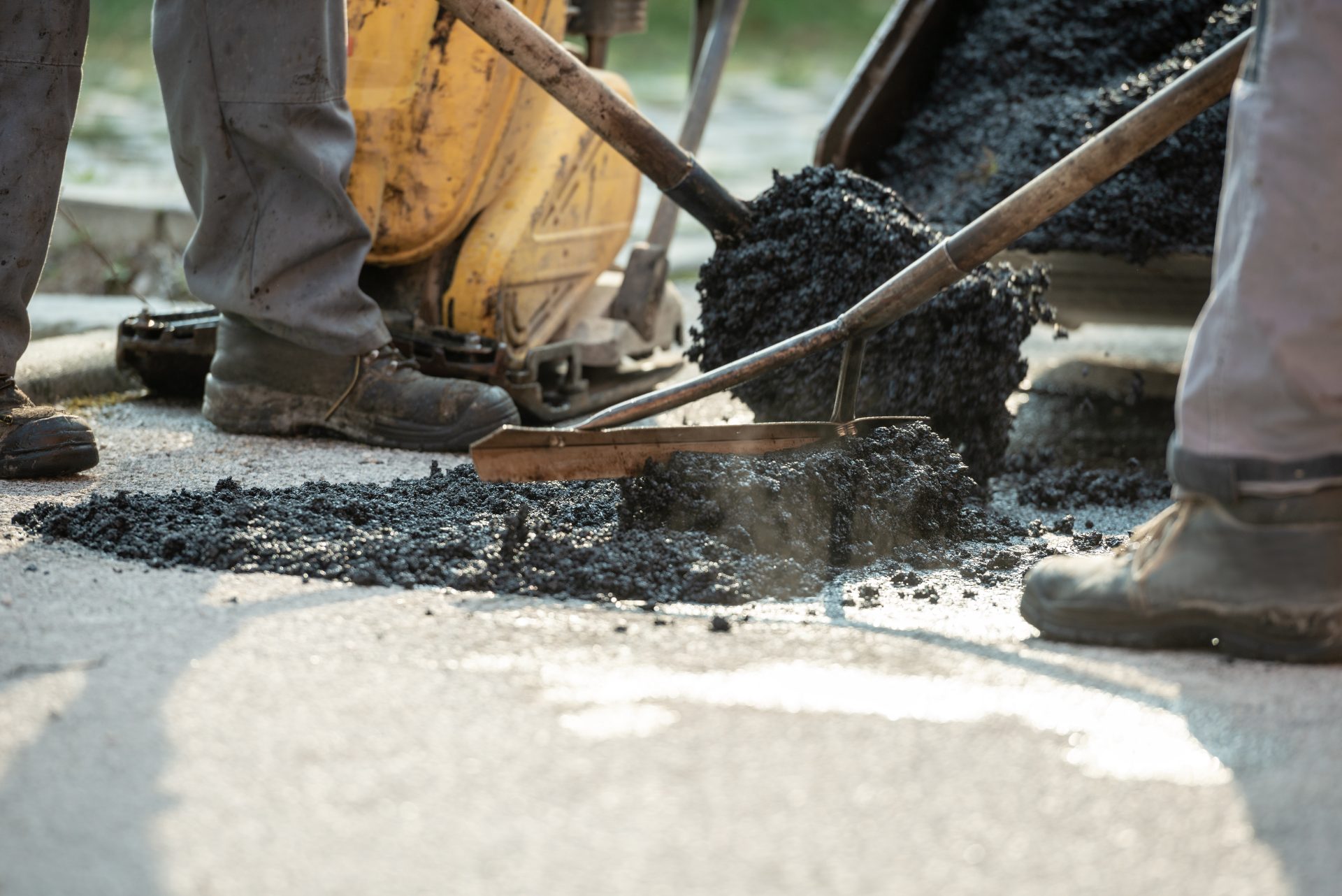 two construction workers patching bump in the road 2023 11 27 04 49 19 utc