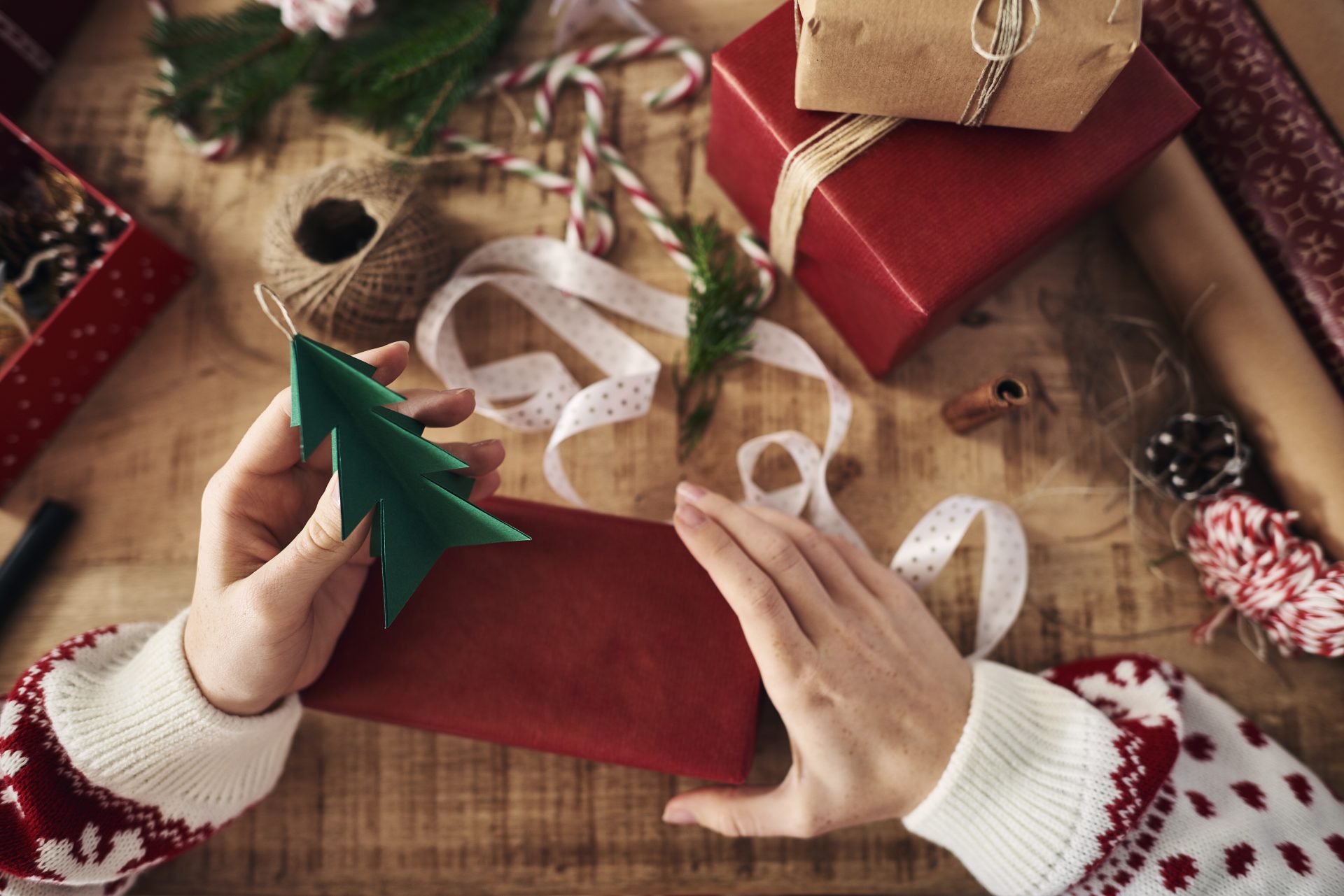 woman attaching christmas tree shaped decoration o 2024 06 28 21 52 35 utc