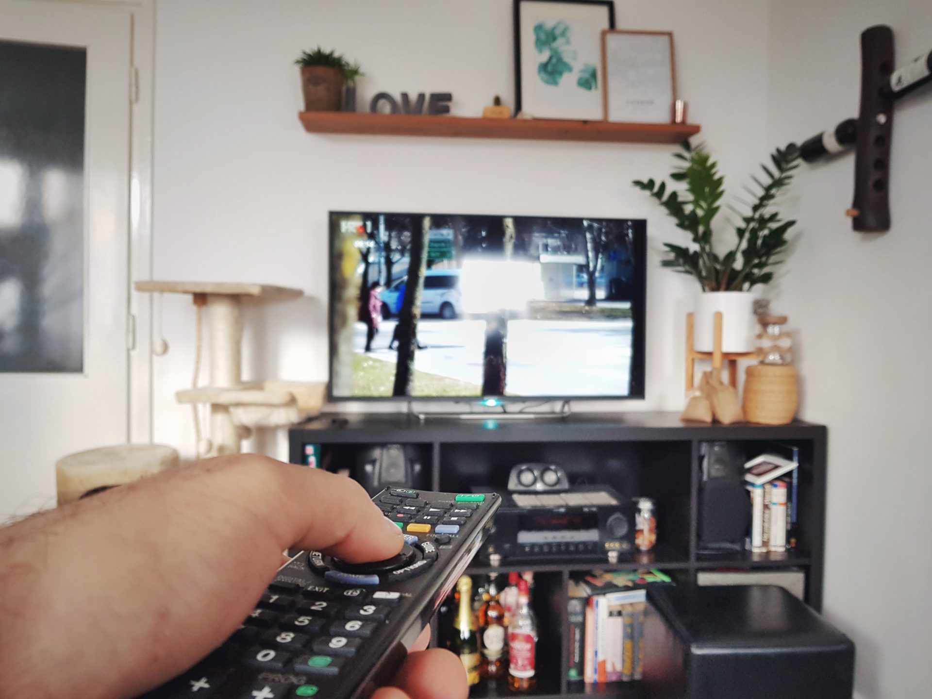 personal perspective of hand holding tv remote pe 2023 11 27 04 55 38 utc