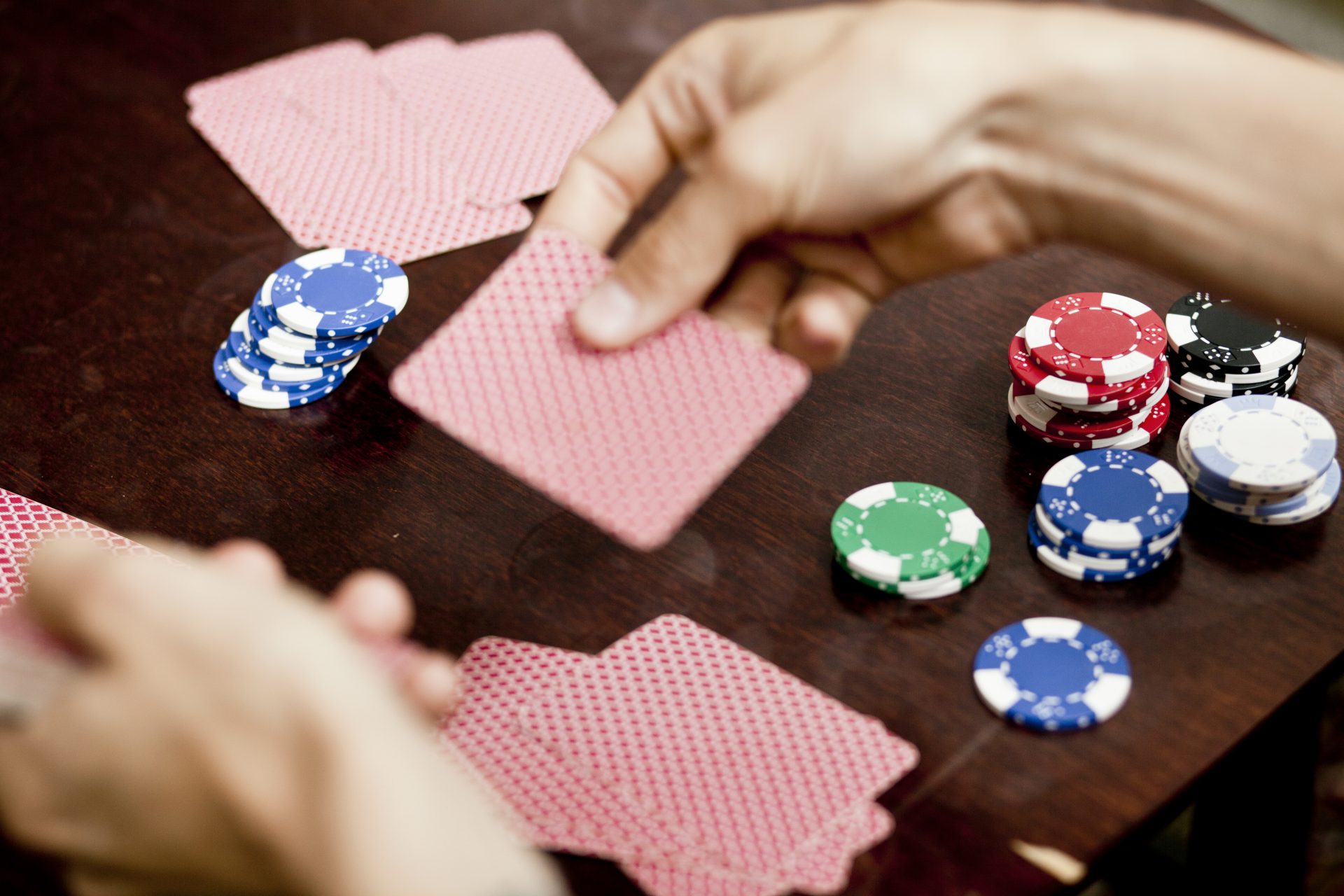 cropped image of man s hands playing cards at home 2024 10 18 05 40 06 utc