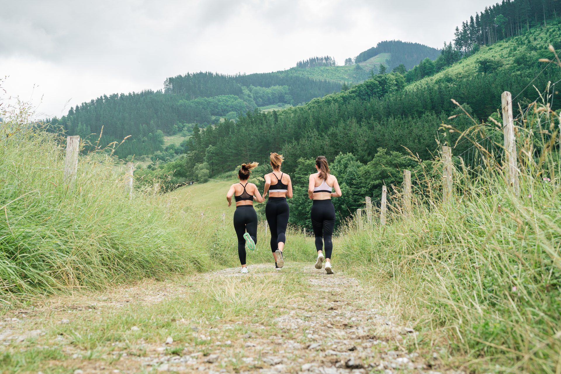 rear view three girls running across a road throug 2024 05 27 20 12 07 utc