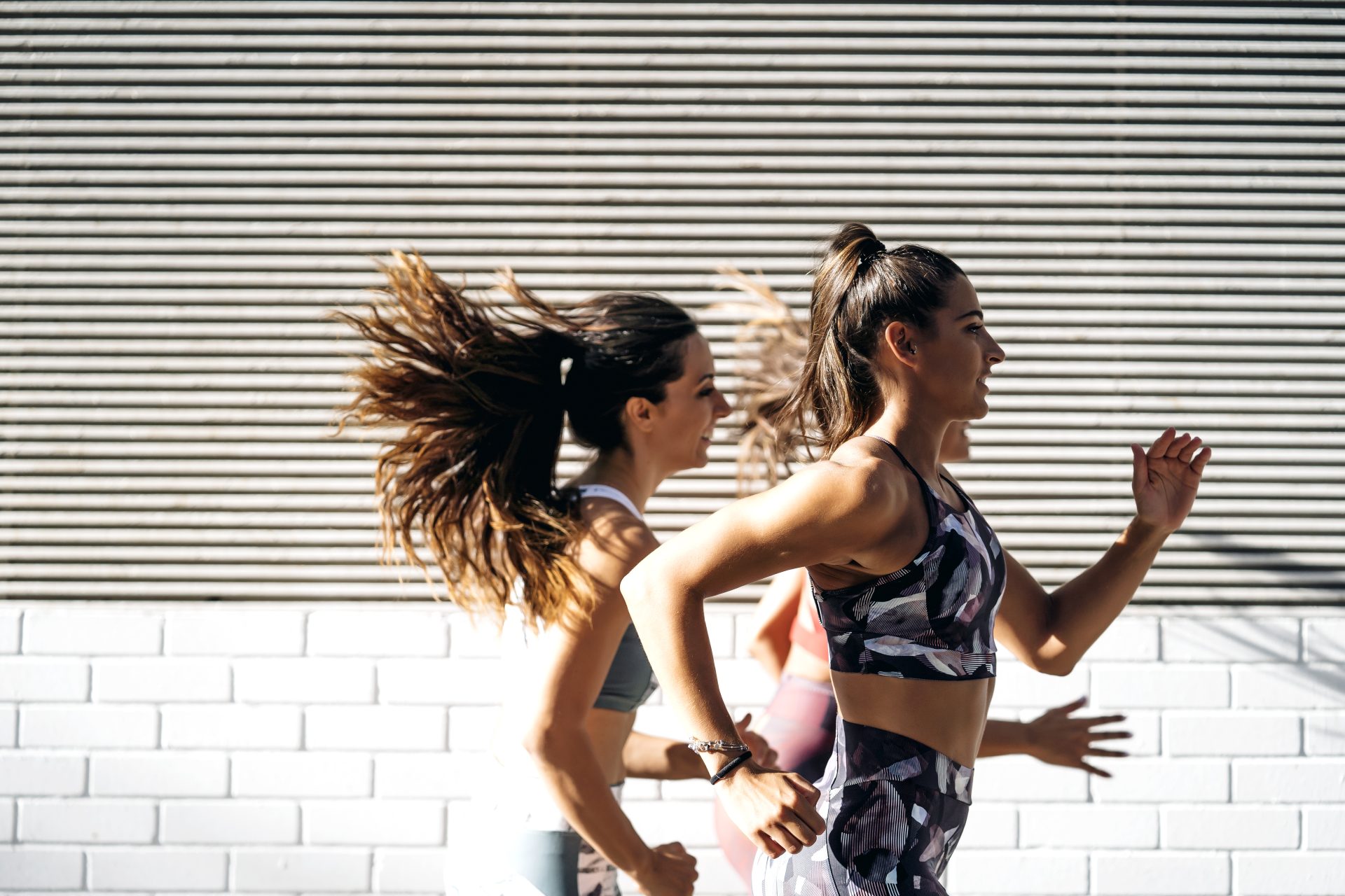 three sporty young women running in the city 2024 09 22 22 20 25 utc