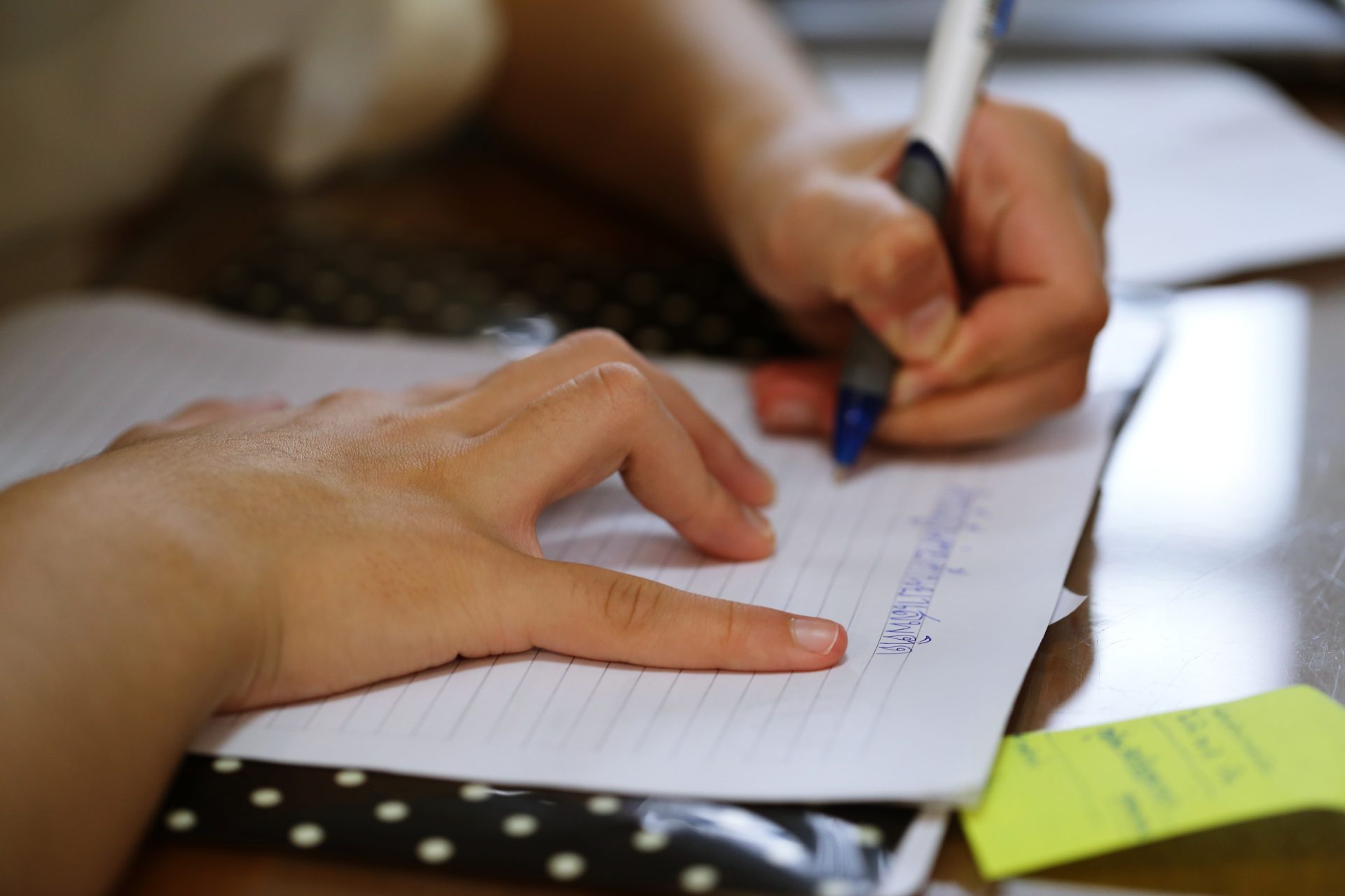 student holding pen in hand doing homework closeup 2024 12 07 12 46 20 utc