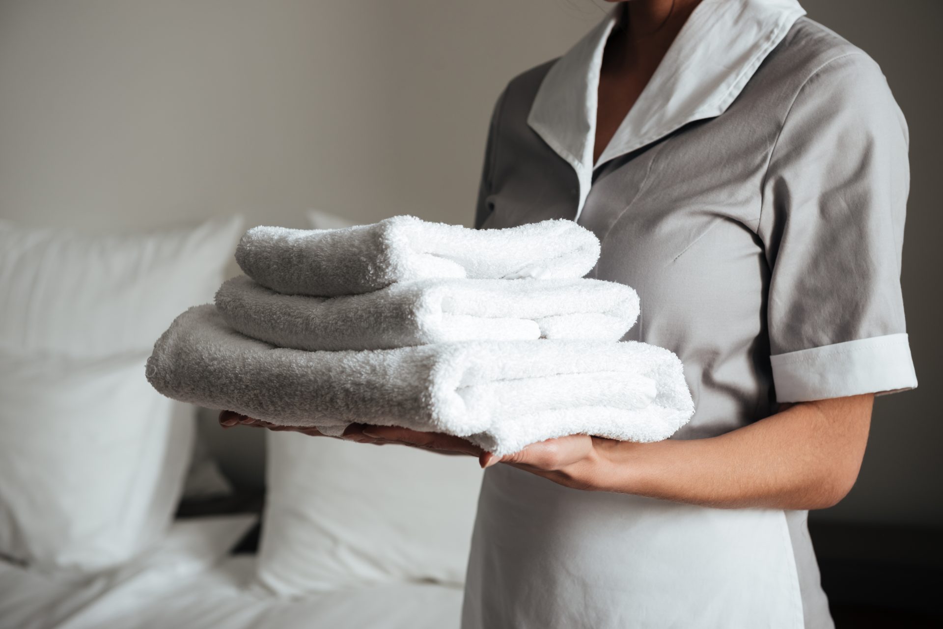 young maid holding folded towels 2025 02 16 09 24 45 utc