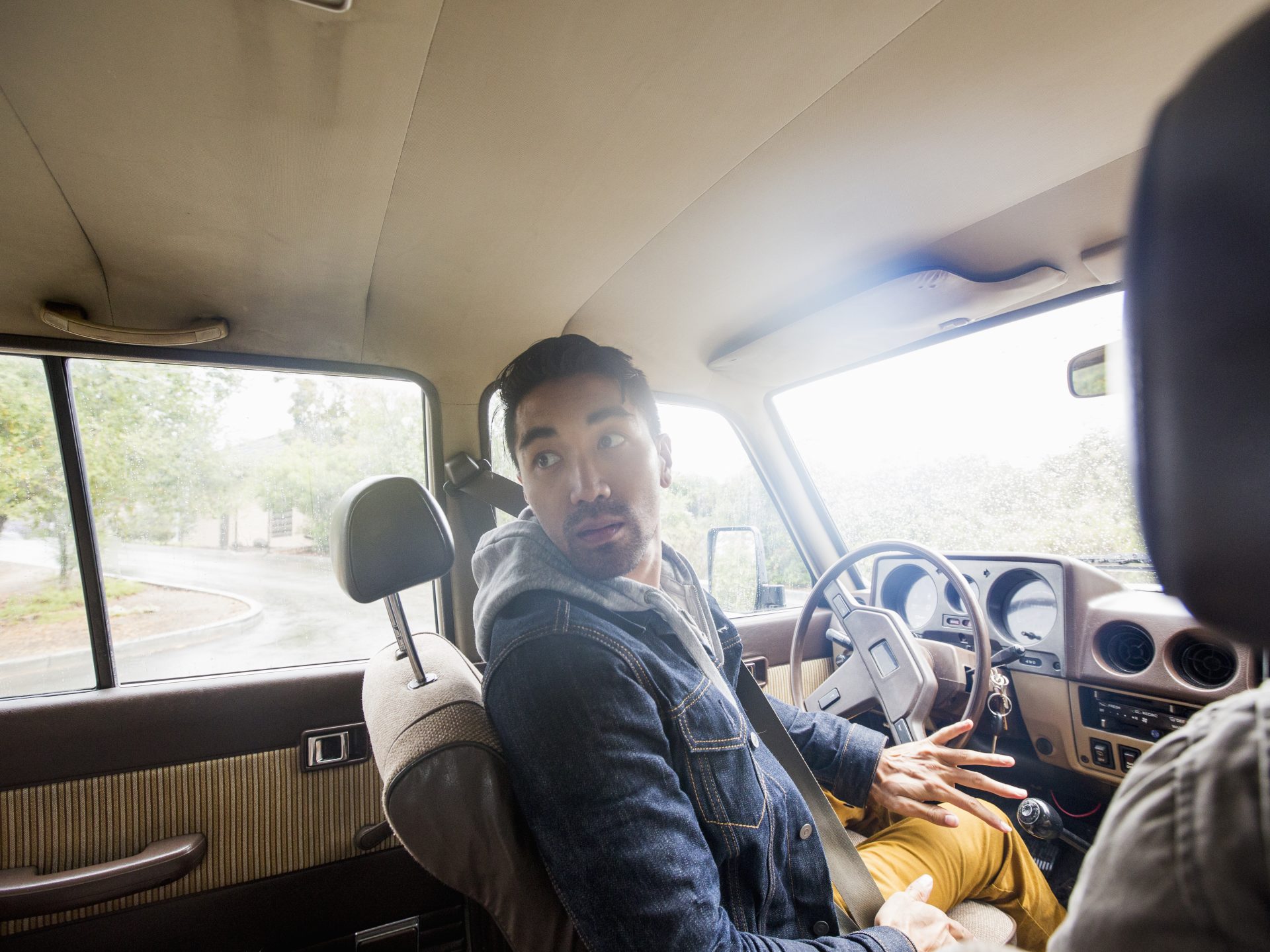 young man in a car in the driver seat looking ov 2025 04 04 05 50 42 utc