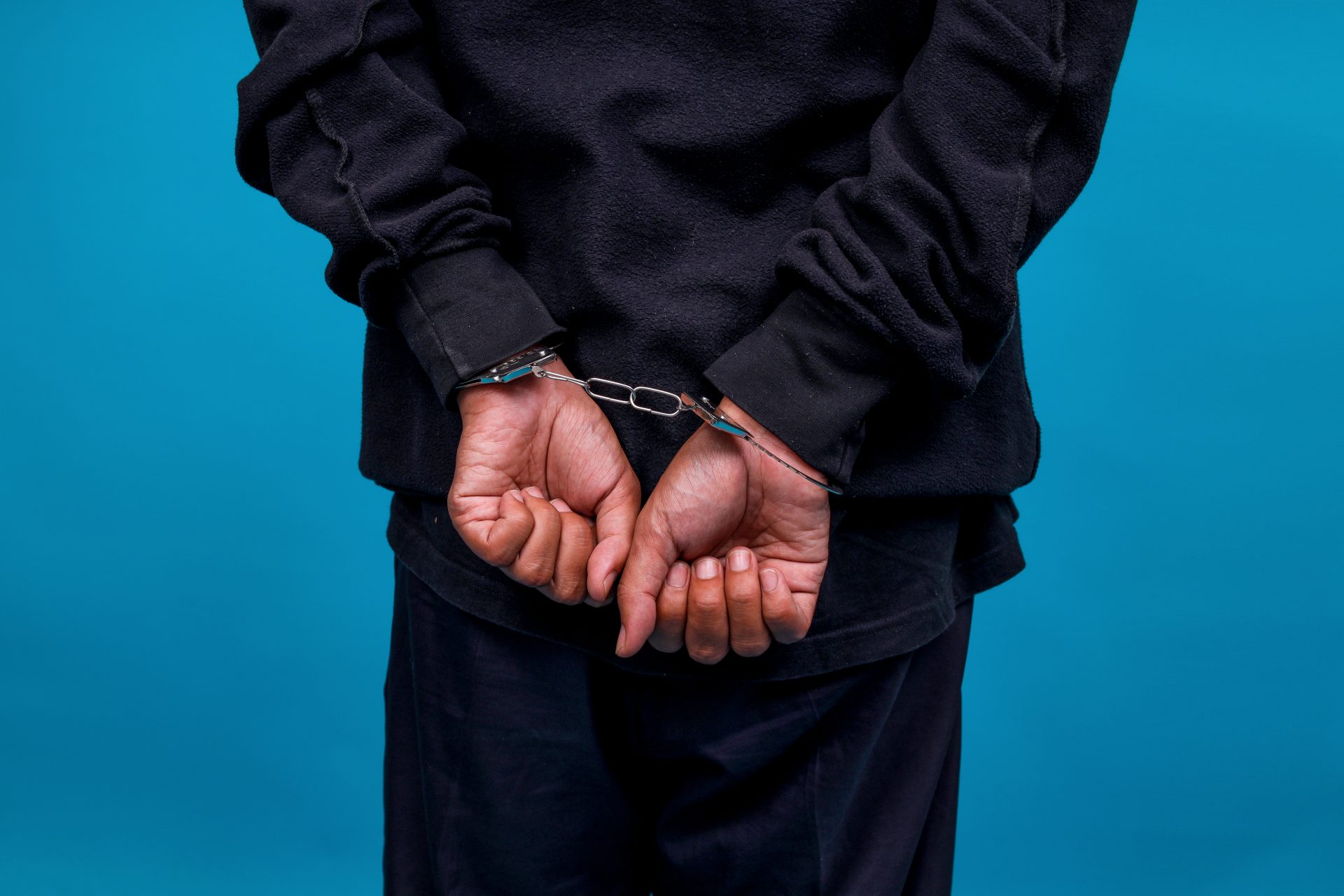 close up rear view of hands in handcuffs after get 2025 04 28 12 34 17 utc