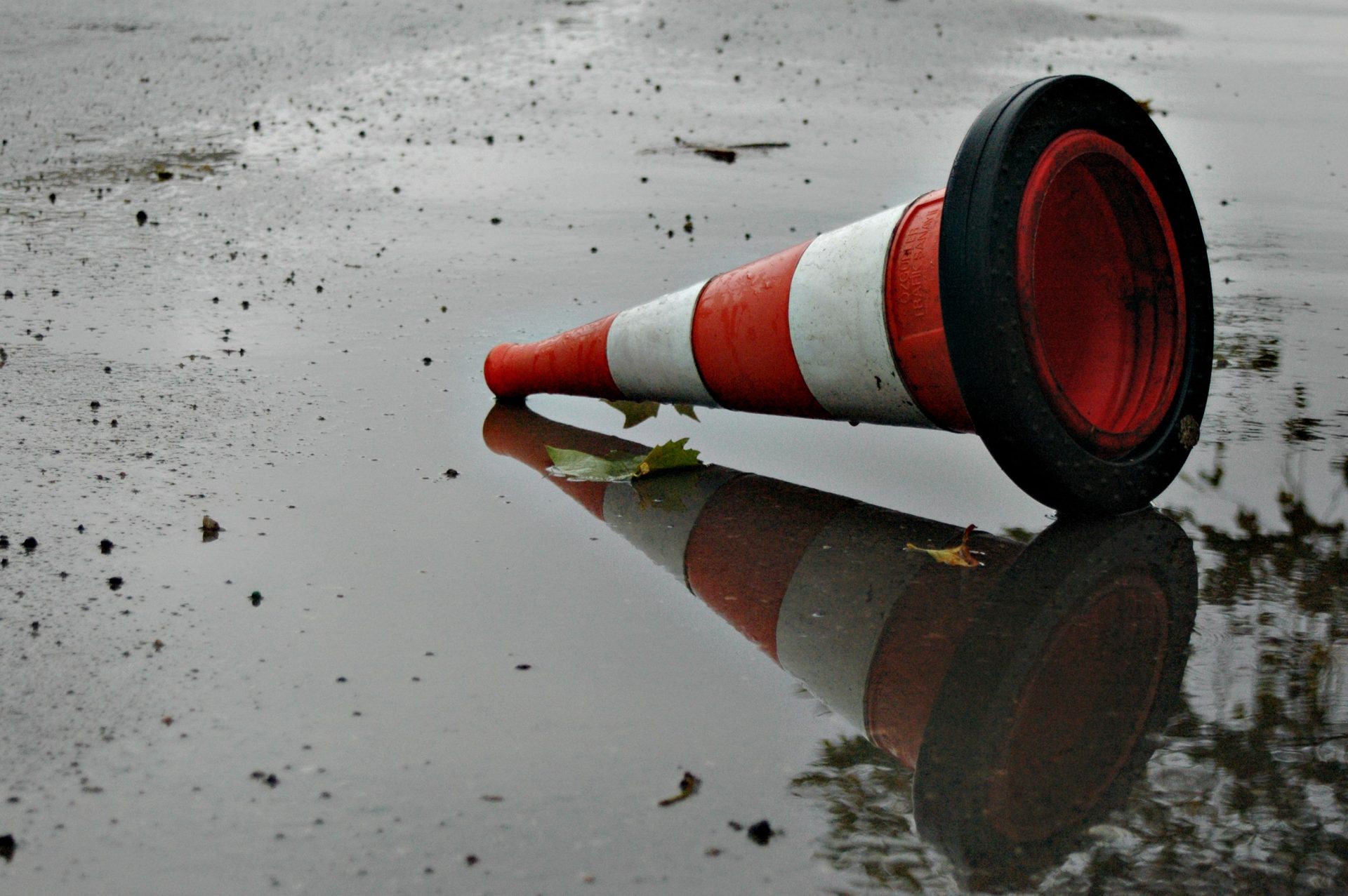 striped traffic cone dropped on shallow puddle in 2025 02 04 01 42 56 utc