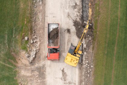 excavator digging ground near the field and loadin 2025 03 05 21 29 06 utc