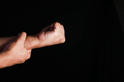 man suffering pain in hand isolated on black 2024 12 12 05 52 38 utc