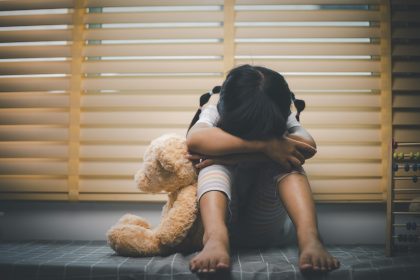 close up lonely little girl hugging toy sitting a 2025 02 16 09 26 43 utc