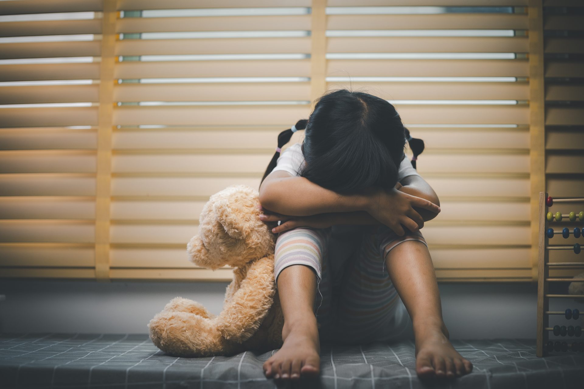 close up lonely little girl hugging toy sitting a 2025 02 16 09 26 43 utc