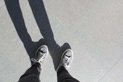looking down at my sneakers and the shadow of my l 2025 01 08 02 34 00 utc