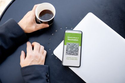 man hold phone with app of coronavirus vaccination 2026 01 09 06 53 30 utc