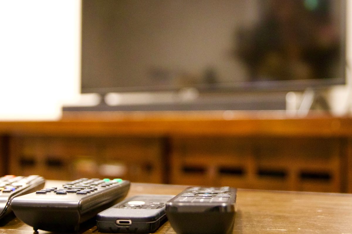 multiple remote controls lined up with tv in backg 2026 01 05 23 25 55 utc