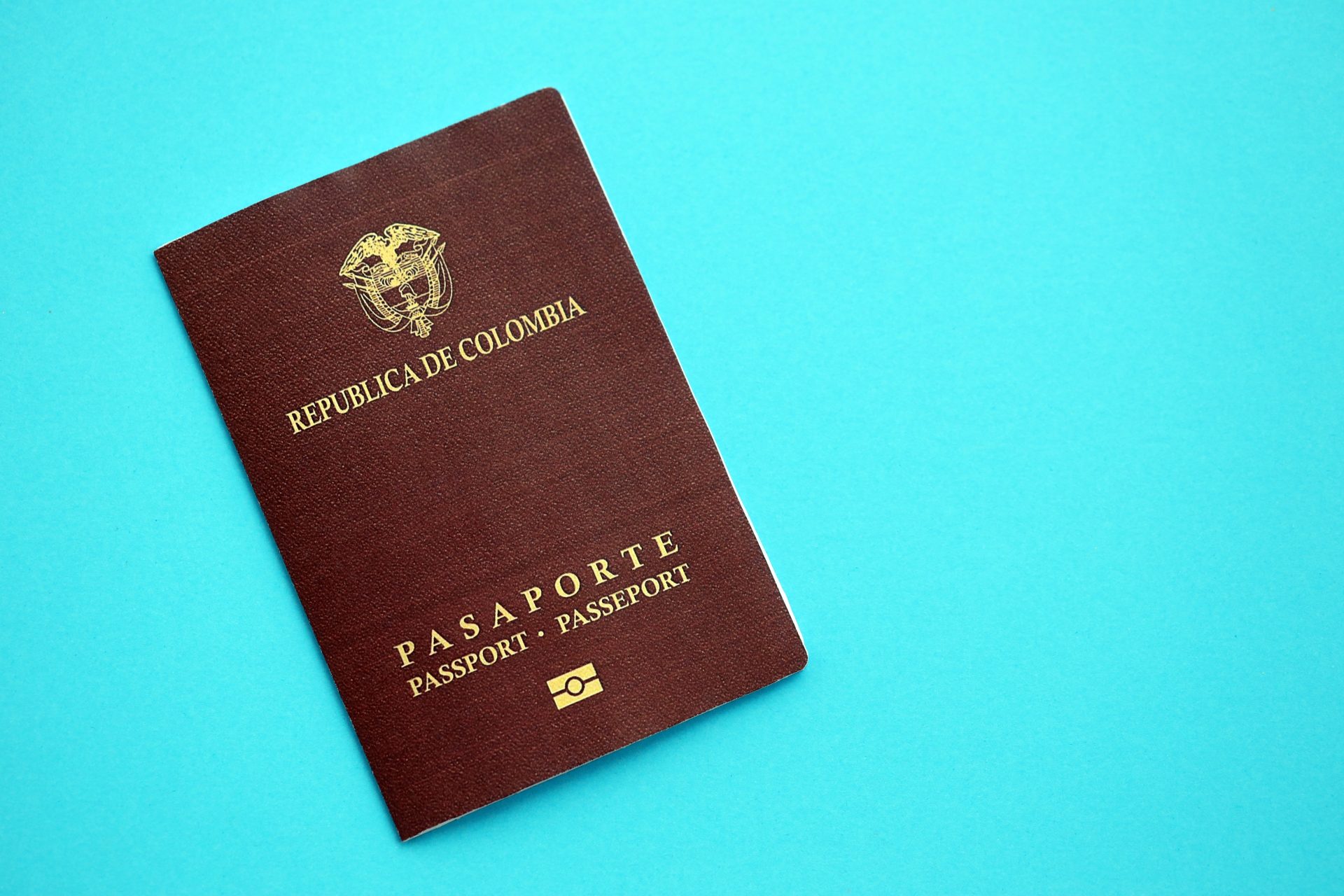 colombia republic red passport on light blue table 2026 01 11 11 07 17 utc