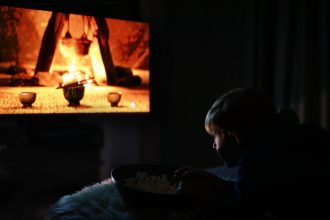boy watches movie in the dark room 2026 03 17 14 43 02 utc