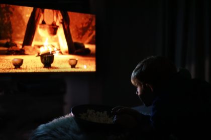 boy watches movie in the dark room 2026 03 17 14 43 02 utc